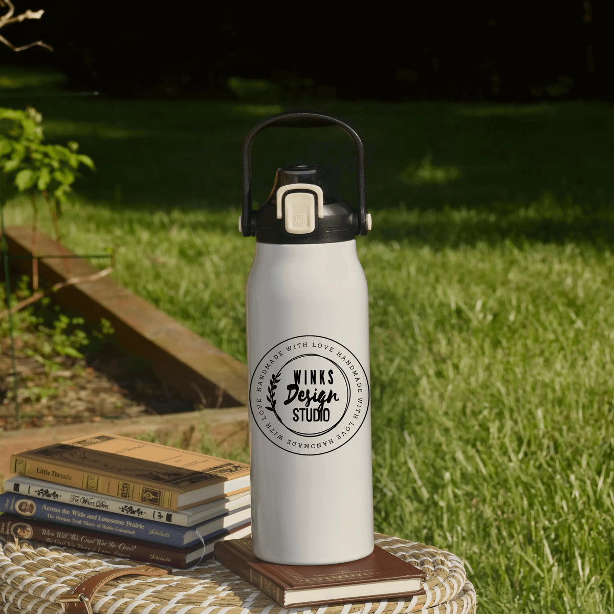 Winks Design Studio LLC 57 oz water bottle with round logo, durable plastic drink container for outdoor and daily use.