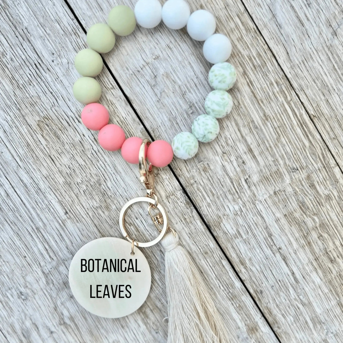 Pink botanical custom silicone wristlet keychain by Winks Design Studio, LLC, featuring a floral design on a durable wristlet strap.