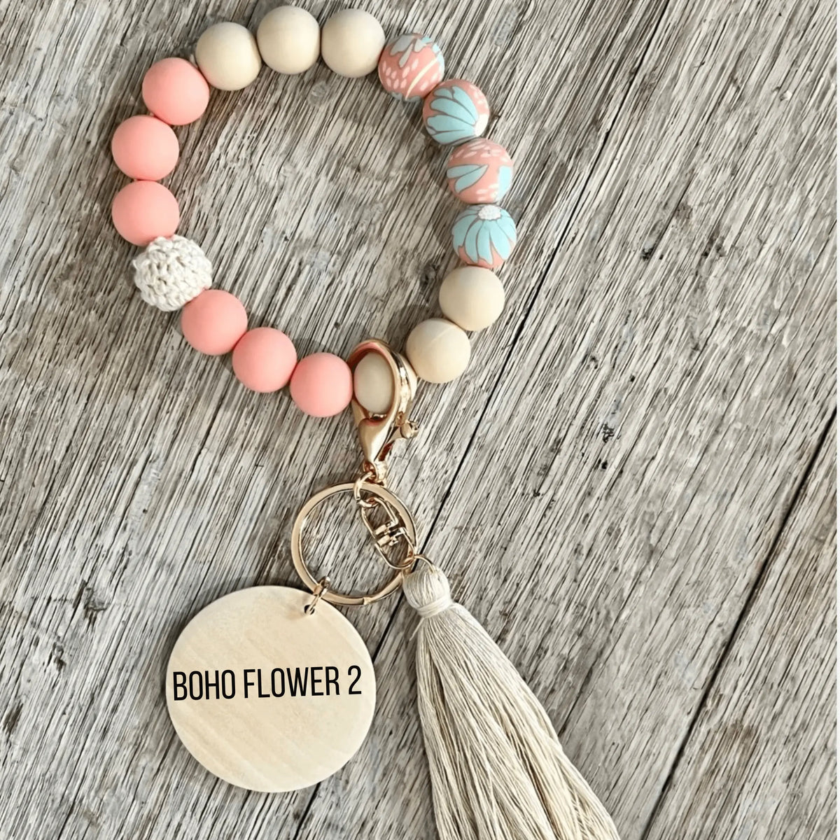 Pink botanical custom silicone wristlet keychain by Winks Design Studio, LLC, featuring a floral design and convenient keyring attachment.